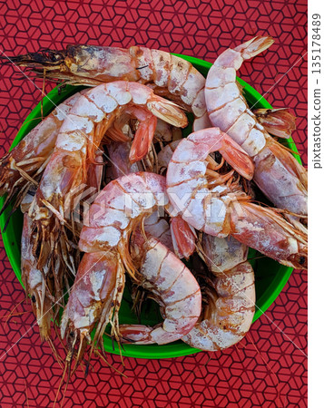 A bowl of shrimp with a green bowl 135178489