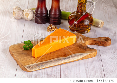 Yellow cheddae cheese over board 135178570