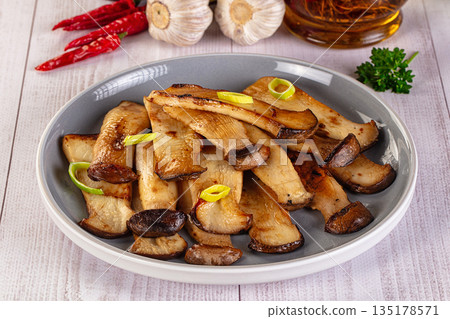 Roasted eringi mushrooms in the plate 135178571