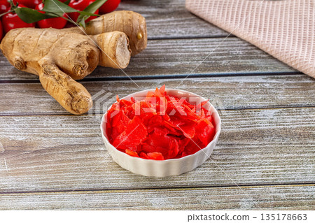 Red marinated sliced ginger roots Red marinated sliced ginger roots 135178663