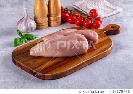 Fresh raw chicken breast over board Fresh raw chicken breast over board 135178786