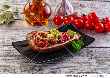 Baked eggplant with tomato and leek Baked eggplant with tomato and leek 135178803