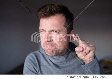 Suspicious male person looking with disbelief, doubt and judgment. Suspicious male person looking with disbelief, doubt and judgment. 135178892