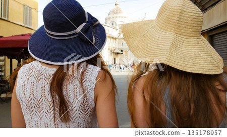Two young traveling women walking on the streets Two young traveling women walking on the streets 135178957