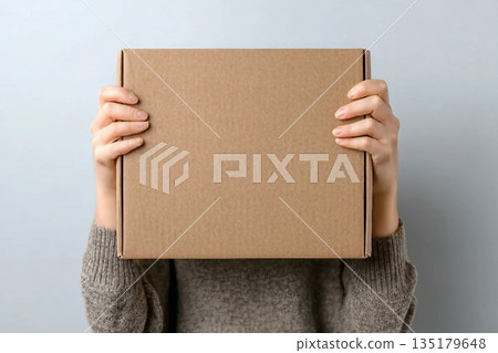 Woman with blank cardboard box on white background, top view. Mockup for design Woman with blank cardboard box on white background, top view. Mockup for design 135179648