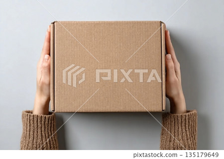 Woman with blank cardboard box on white background, top view. Mockup for design Woman with blank cardboard box on white background, top view. Mockup for design 135179649
