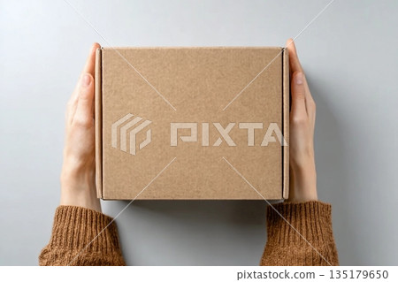 Woman with blank cardboard box on white background, top view. Mockup for design Woman with blank cardboard box on white background, top view. Mockup for design 135179650