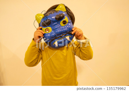 A child wearing a blue demon mask A child wearing a blue demon mask 135179962
