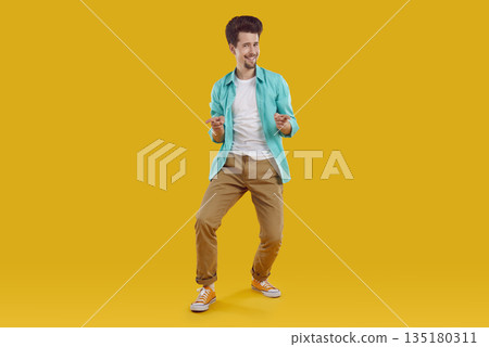 Happy man in casual clothes standing on yellow background, pointing at you and smiling 135180311