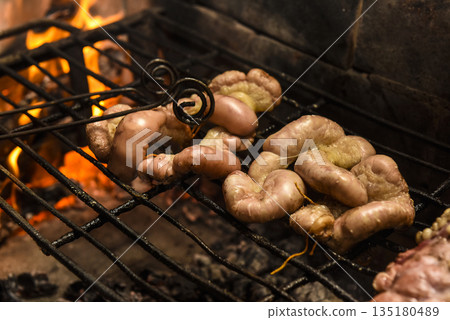 Cow bowels presented on a wooden board with ingredients, ready to grill Cow bowels presented on a wooden board with ingredients, ready to grill 135180489