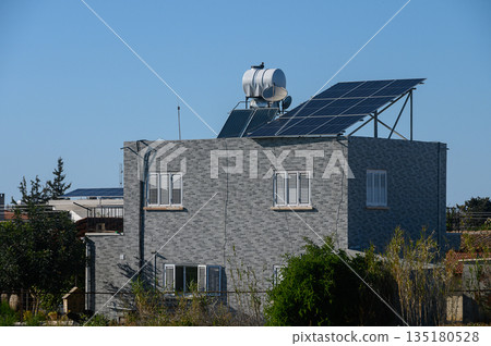 Bright solar panels atop a modern house showcase sustainable energy in a sunny neighborhood 135180528