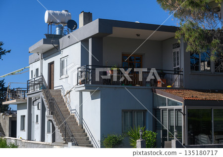 Modern architecture meets sunny days in a vibrant neighborhood overlooking the sea in an urban getaway 135180717