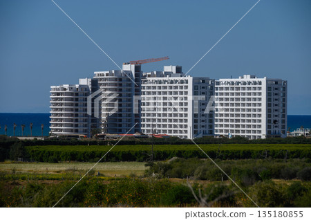 Modern architecture stands against a vibrant coastal backdrop showcasing luxury living by the sea Modern architecture stands against a vibrant coastal backdrop showcasing luxury living by the sea 135180855