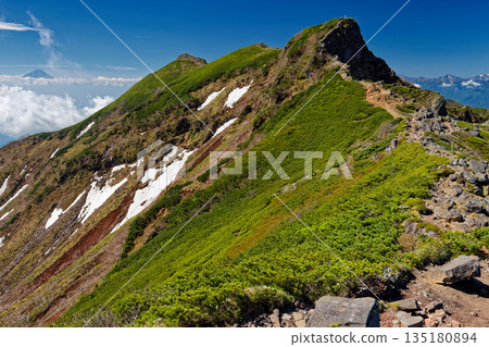 The rocky peaks of Yokodake Okunoin in the Yatsugatake Mountain Range and Mount Fuji above the clouds The rocky peaks of Yokodake Okunoin in the Yatsugatake Mountain Range and Mount Fuji above the clouds 135180894