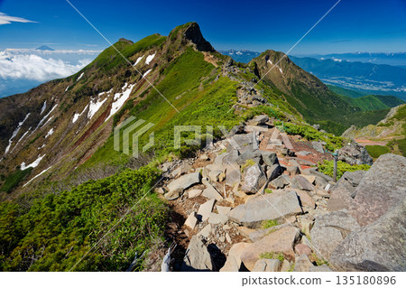 Mount Amida, the rocky peak of Yokodake Okunoin in the Yatsugatake Mountain Range, and Mount Fuji above the clouds Mount Amida, the rocky peak of Yokodake Okunoin in the Yatsugatake Mountain Range, and Mount Fuji above the clouds 135180896