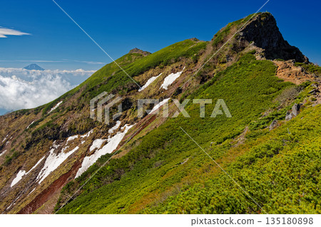 The main peak of the Yatsugatake mountain range, Yokodake, and Mount Fuji above the clouds The main peak of the Yatsugatake mountain range, Yokodake, and Mount Fuji above the clouds 135180898