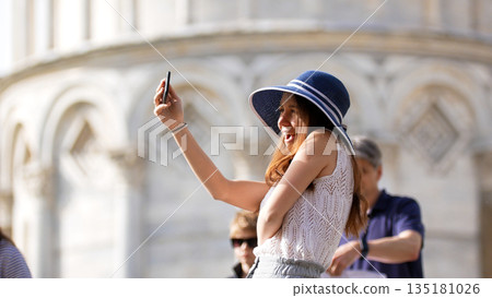 Young woman taking selfie with smartphone on vacation 135181026