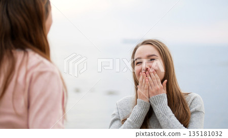 Young woman reacting with surprised happy expression 135181032