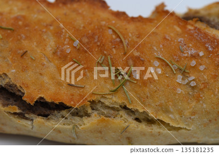 Freshly baked bread with herbs and sea salt delighting the senses in a rustic kitchen environment Freshly baked bread with herbs and sea salt delighting the senses in a rustic kitchen environment 135181235