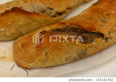 Unique artisan bread loaf shaped by skilled hands in a quaint bakery during the morning hours of a sunny day 135181392