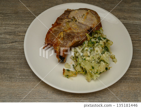 Golden Brown Pork Chop with Cauliflower Herb Side Dish Golden Brown Pork Chop with Cauliflower Herb Side Dish 135181446