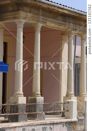 Exploring historical architecture with elegant columns and pastel hues in a charming town 135181562