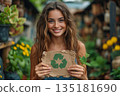 Smiling Woman Holding Recycled Paper In Garden 135181690