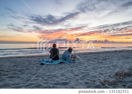 sunrise romantic couple on Corsican coast near Bastia Etang de Biguglia Camping San Daminao Beachside Corse sunrise romantic couple on Corsican coast near Bastia Etang de Biguglia Camping San Daminao Beachside Corse 135182351