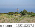 panoramic view village mountainous landscape towards the Gulf of Porto in sunlight with blue skies and spectacular cloud 135182378