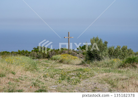 panoramic view village mountainous landscape towards the Gulf of Porto in sunlight with blue skies and spectacular cloud panoramic view village mountainous landscape towards the Gulf of Porto in sunlight with blue skies and spectacular cloud 135182378
