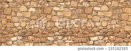 Ancient rough hewn stone wall texture pattern Ancient rough hewn stone wall texture pattern 135182385