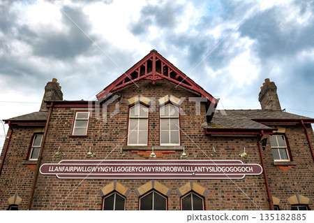 Name Plate On Trainstation Building Of Villag Llanfairpwllgwyngyllgogerychwyrndrobwllllantysiliogogogoch in Wales, UK Name Plate On Trainstation Building Of Villag Llanfairpwllgwyngyllgogerychwyrndrobwllllantysiliogogogoch in Wales, UK 135182885
