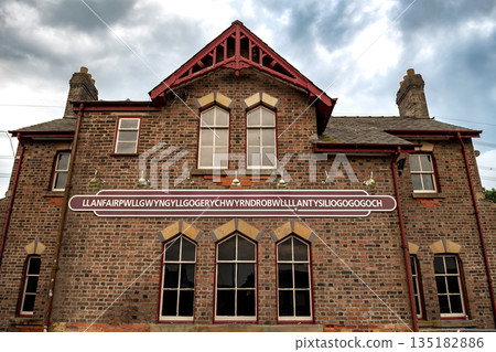 Name Plate On Trainstation Building Of Villag Llanfairpwllgwyngyllgogerychwyrndrobwllllantysiliogogogoch in Wales, UK Name Plate On Trainstation Building Of Villag Llanfairpwllgwyngyllgogerychwyrndrobwllllantysiliogogogoch in Wales, UK 135182886