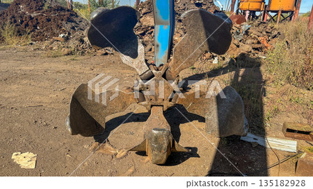 Industrial orange-peel grab bucket for scrap metal handling at a recycling yard. Industrial orange-peel grab bucket for scrap metal handling at a recycling yard. 135182928