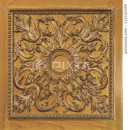 Ornate wood carving panel with baroque floral pattern 135182949