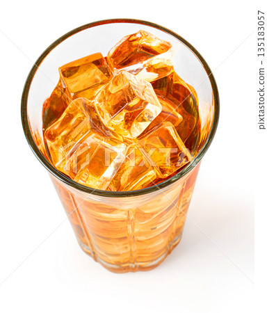 Iced tea in glass with ice cubes, top view Iced tea in glass with ice cubes, top view 135183057