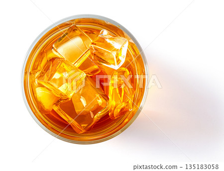 Whiskey glass with ice cubes overhead view Whiskey glass with ice cubes overhead view 135183058