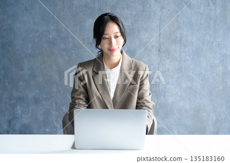 woman using a laptop in the office woman using a laptop in the office 135183160