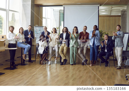 Happy diverse business team applauding after successful presentation at business seminar Happy diverse business team applauding after successful presentation at business seminar 135183166