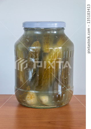 Homemade pickled cucumber in glass jar. 135183413