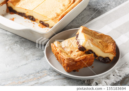 Far Breton is an iconic prune dessert from the Brittany region of France closeup on the plate. Horizontal 135183694