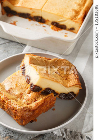 Far Bretonis a traditional cake or dessert a flan style eggs and milk custard with Prunes closeup on the plate. Vertical 135183698