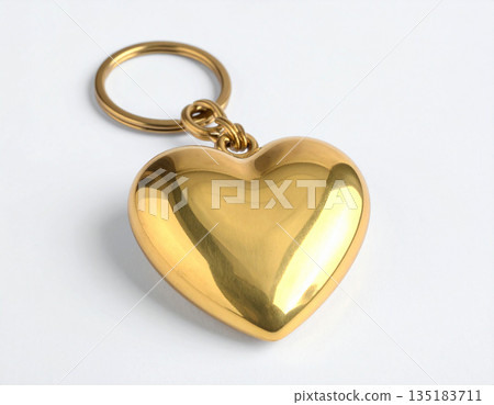 Celebration design. Metal heart-shaped keychain on white background. Celebration design. Metal heart-shaped keychain on white background. 135183711