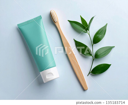 Healthy lifestyle blogs. Minimalistic bamboo toothbrush with a tube of natural toothpaste on a white background. Health care. Oral hygiene. 135183714