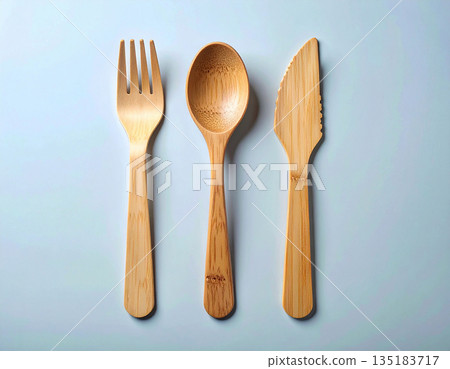 Street food. Set of eco-friendly bamboo cutlery: wooden spoon, fork and knife on a white background. 135183717