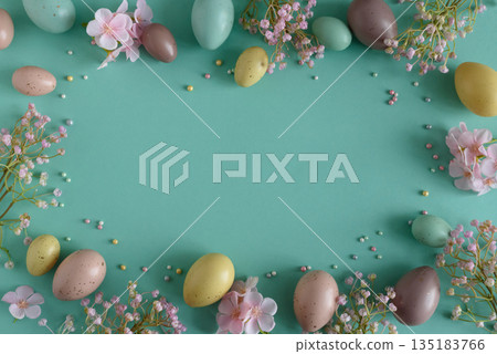 Pastel Easter Eggs and Flowers on Teal Background. Festive Spring Flatlay Pastel Easter Eggs and Flowers on Teal Background. Festive Spring Flatlay 135183766