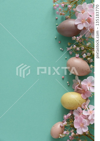 Pastel Easter Eggs and Flowers on Teal Background. Festive Spring Flatlay Pastel Easter Eggs and Flowers on Teal Background. Festive Spring Flatlay 135183770