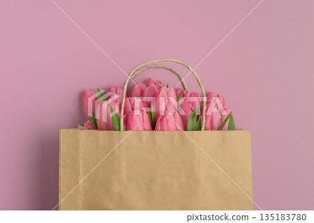 Gift Bag with Pink Tulips on Pink Background. Valentine's or Mother's Day Celebration Gift Bag with Pink Tulips on Pink Background. Valentine's or Mother's Day Celebration 135183780