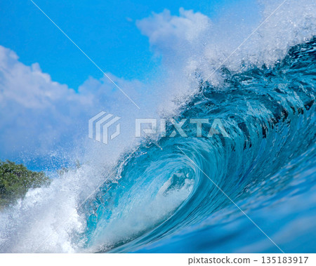Vast Ocean Wave Crashing Fiercely, Powerful Surf Surging Beneath Bright Sky 135183917