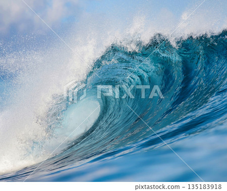 Blue wave breaking on a beach in sea 135183918
